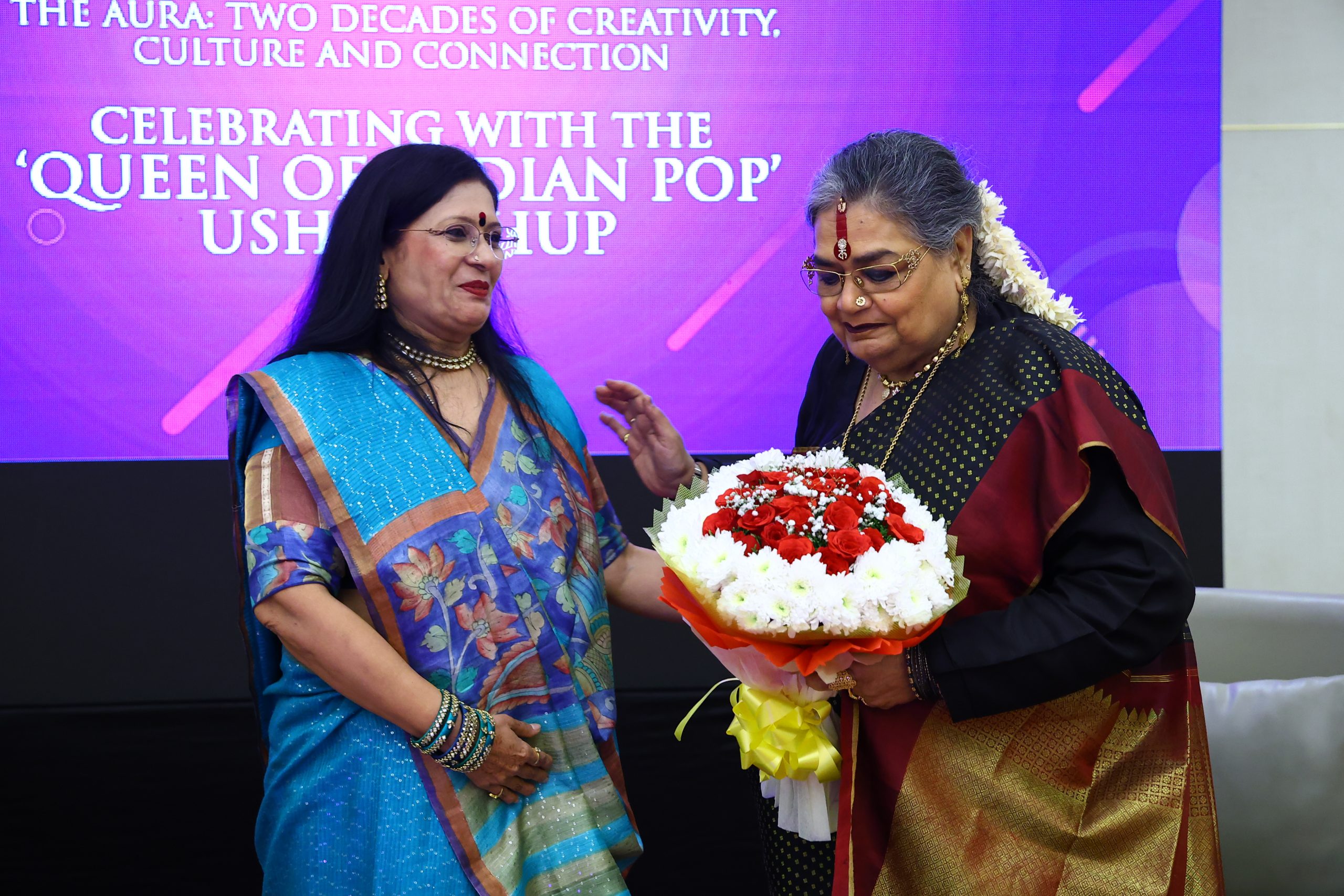 The Aura’s 20th anniversary celebration was a grand and unforgettable evening, brimming with elegance, music, laughter, and heartfelt nostalgia. On 25th October 2025, the iconic Usha Uthup mesmerized the audience with her dynamic presence, timeless charm, and powerful performance. The unveiling of The Aura at 20 video and souvenir added a golden touch, beautifully showcasing two glorious decades of achievements, sisterhood, and success — a truly magical night to be remembered for years to come.